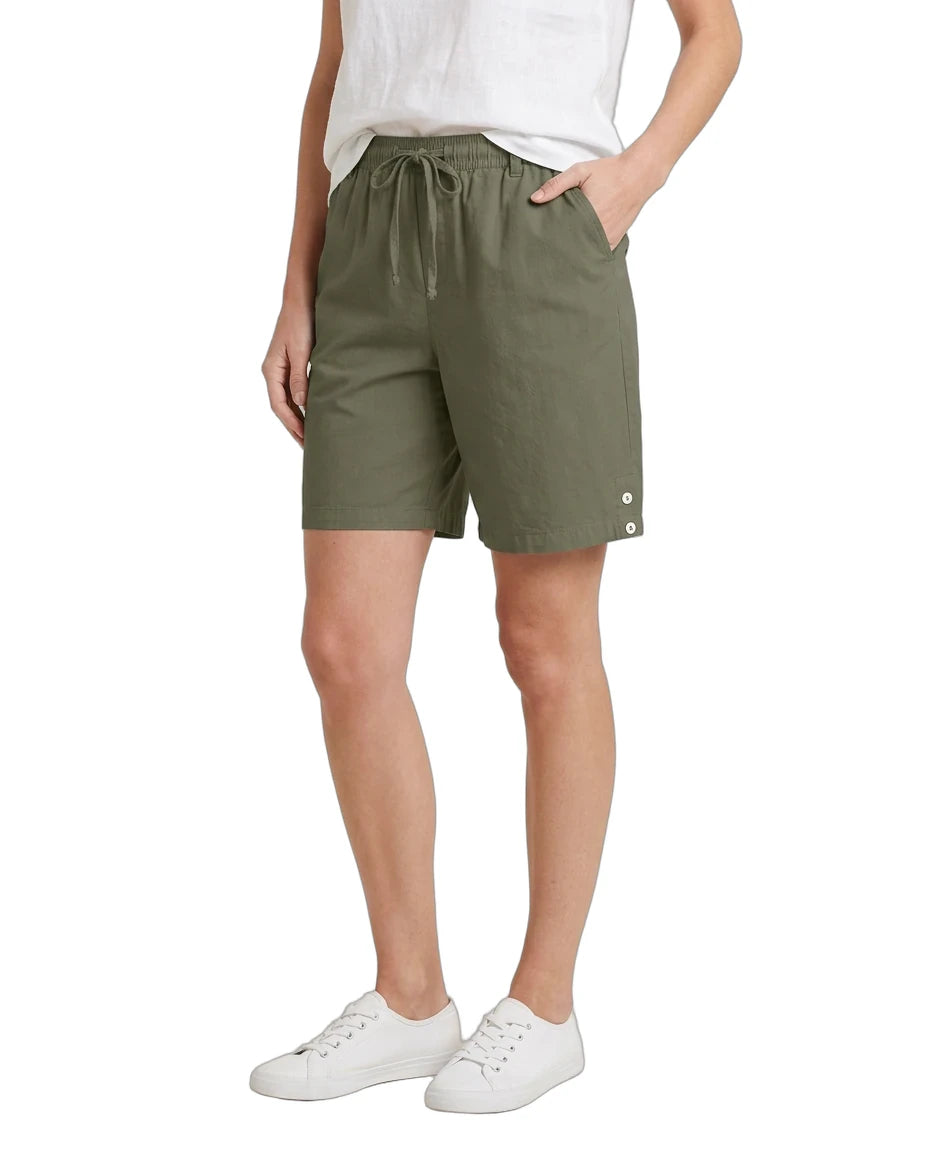 Person wearing olive green shorts on a white background