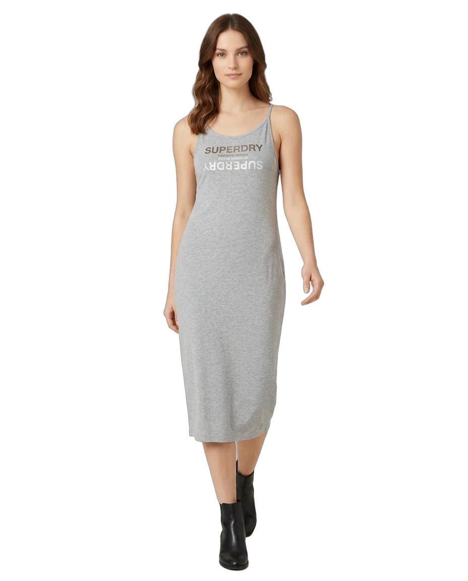 A woman modeling a light gray sleeveless midi dress with 'SUPERDRY AUGUSTS' printed in dark gray across the chest, paired with black ankle boots, on a solid white background.