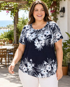 Woman wearing a navy floral top outdoors